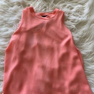 Peach colored sleeveless blouse